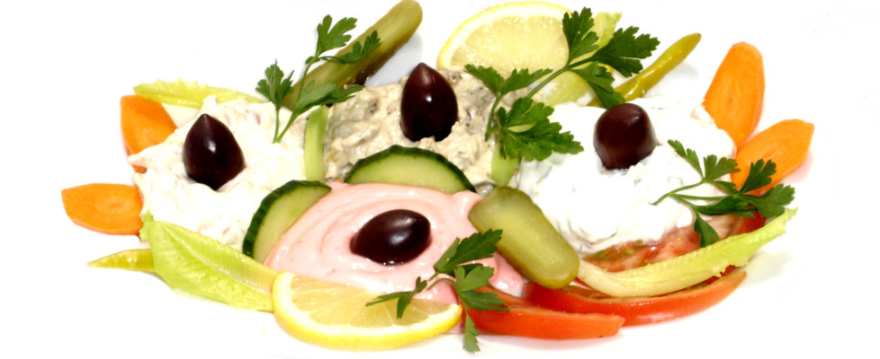 Griechische Vorspeisen mit Cremes, Oliven und frischem Gemüse